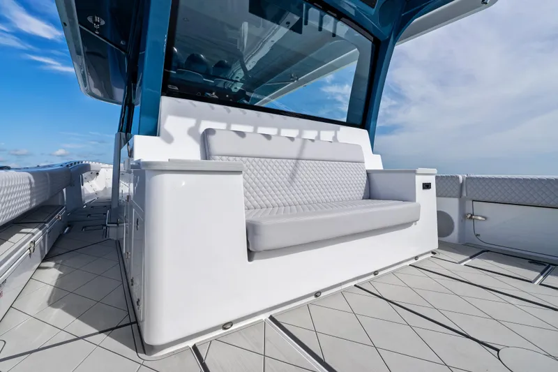 Slide: The Image of Luxury seating on 2025 HCB 56 Suenos GIX yacht deck, under clear sky. - 47