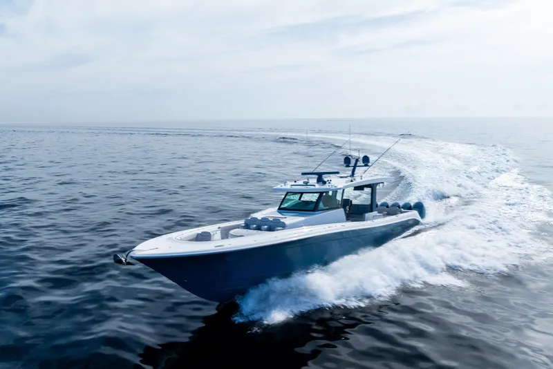 Slide: The Image of 2025 HCB 56 Suenos GIX cruising on open water, creating a dynamic wake. - 59