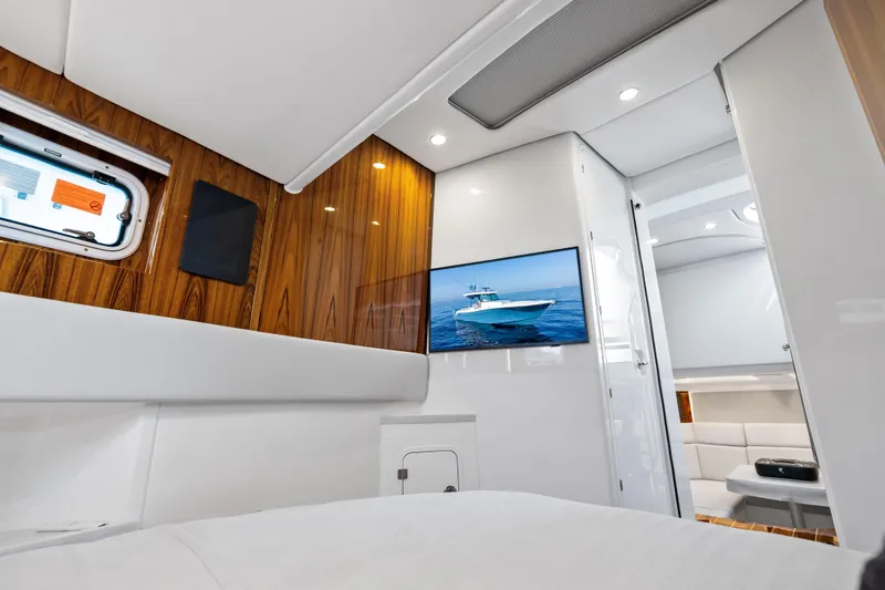 Slide: The Image of Luxurious interior of 2025 HCB 56 Suenos GIX yacht with wood paneling and TV. - 61