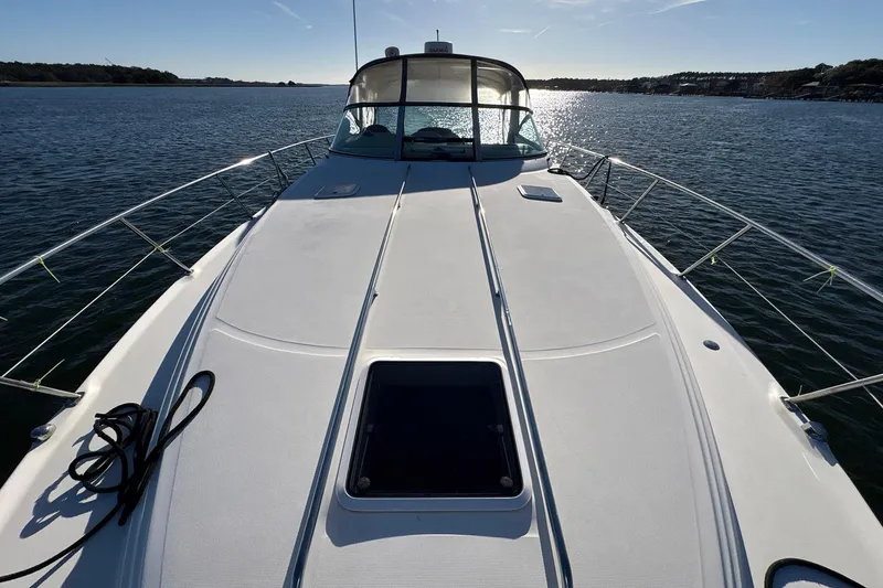 Slide: The Image of 1999 Sea Ray 380 Sundancer yacht on calm water, sunny day, front deck view. - 17