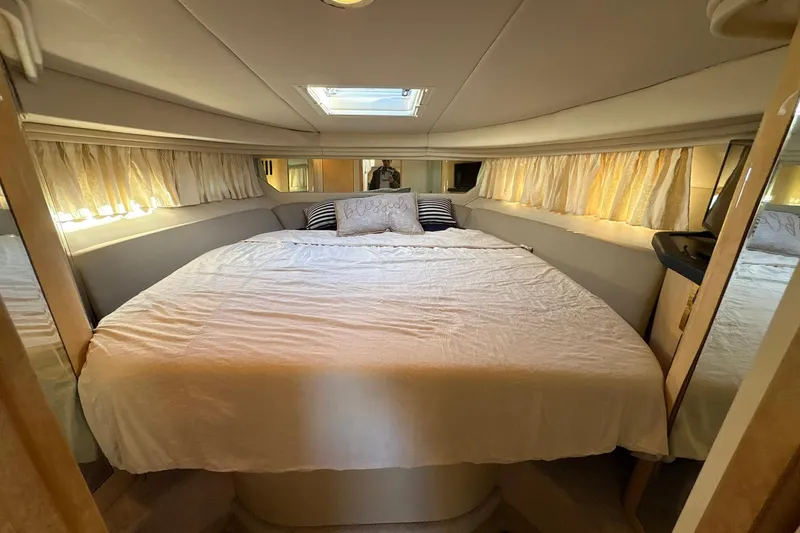 Slide: The Image of Luxurious bedroom interior of 1999 Sea Ray 380 Sundancer yacht with cozy bedding. - 20