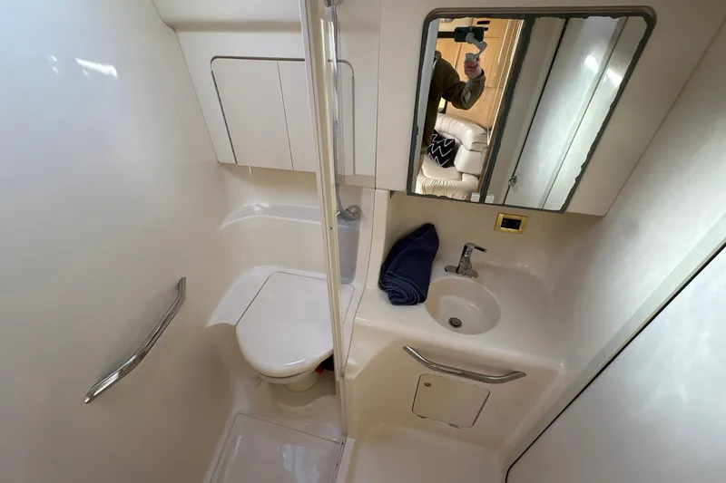 Slide: The Image of Bathroom interior of 1999 Sea Ray 380 Sundancer yacht, featuring sink and toilet. - 21