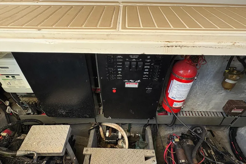 Slide: The Image of Engine compartment of 1999 Sea Ray 380 Sundancer with control panel and fire extinguisher. - 24