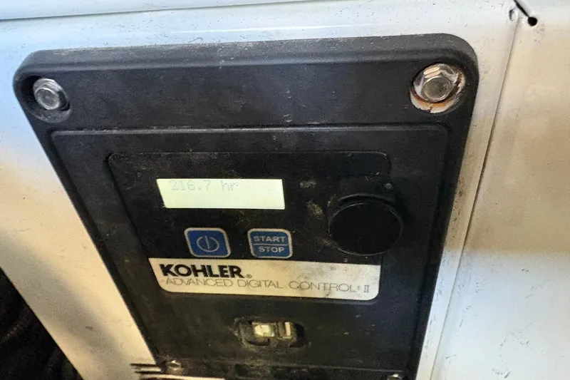 Slide: The Image of Kohler Advanced Digital Control panel on 1999 Sea Ray 380 Sundancer, showing 216.7 hours. - 28