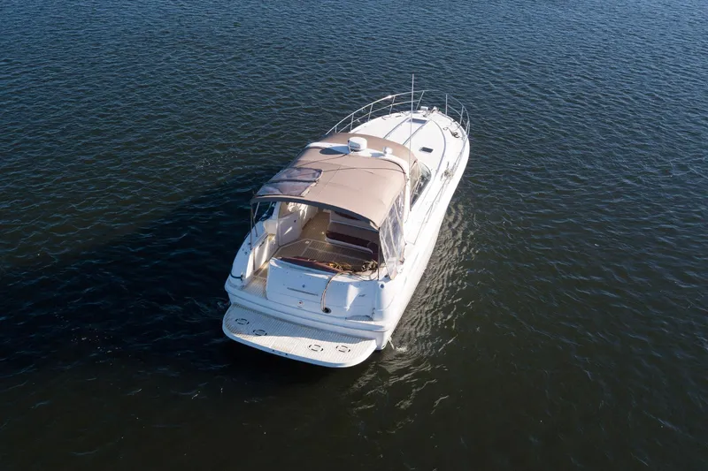 Slide: The Image of 1999 Sea Ray 380 Sundancer cruising on open water, aerial view. - 4