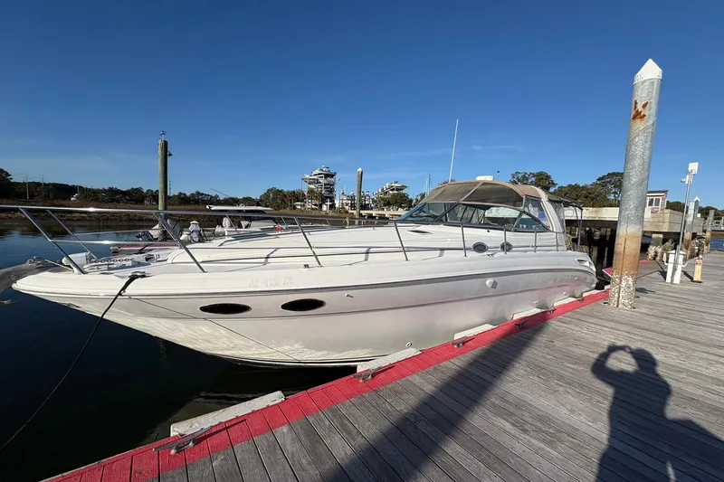 Slide: The Image of 1999 Sea Ray 380 Sundancer docked at marina under clear blue sky. - 5