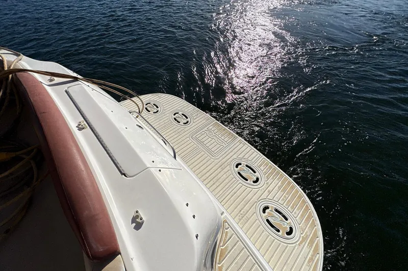 Slide: The Image of 1999 Sea Ray 380 Sundancer swim platform with sunlit water reflection. - 6