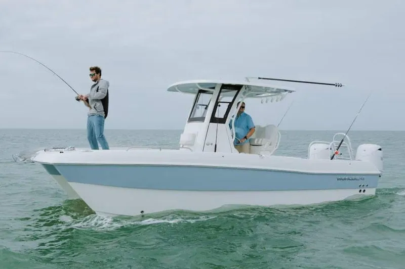 Slide: The Image of 2026 World Cat 235 TE boat on calm water, surrounded by lush greenery. - 1