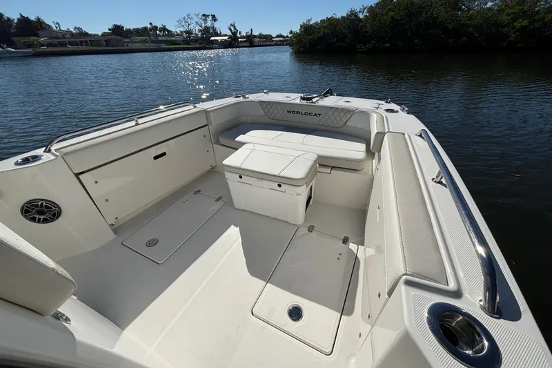 Slide: The Image of 2026 World Cat 235 TE boat interior with spacious seating and storage on calm water. - 12