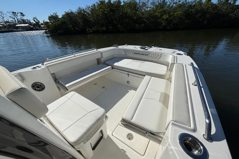 Slide: The Image of 2026 World Cat 235 TE boat interior with spacious seating and sleek design on calm water. - 13