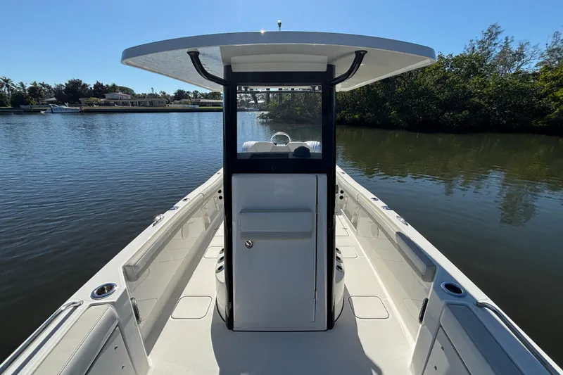 Slide: The Image of 2026 World Cat 235 TE boat on calm water, featuring a sleek center console design. - 14