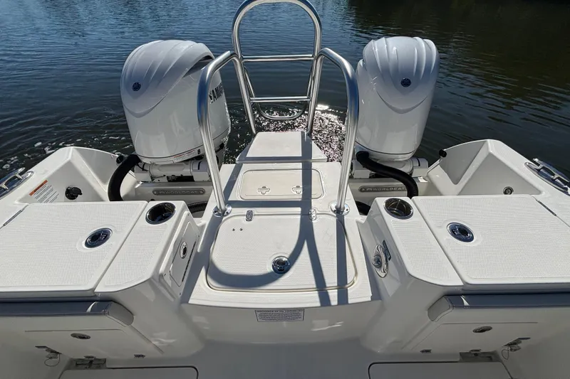 Slide: The Image of 2026 World Cat 235 TE boat with dual engines on calm water. - 7