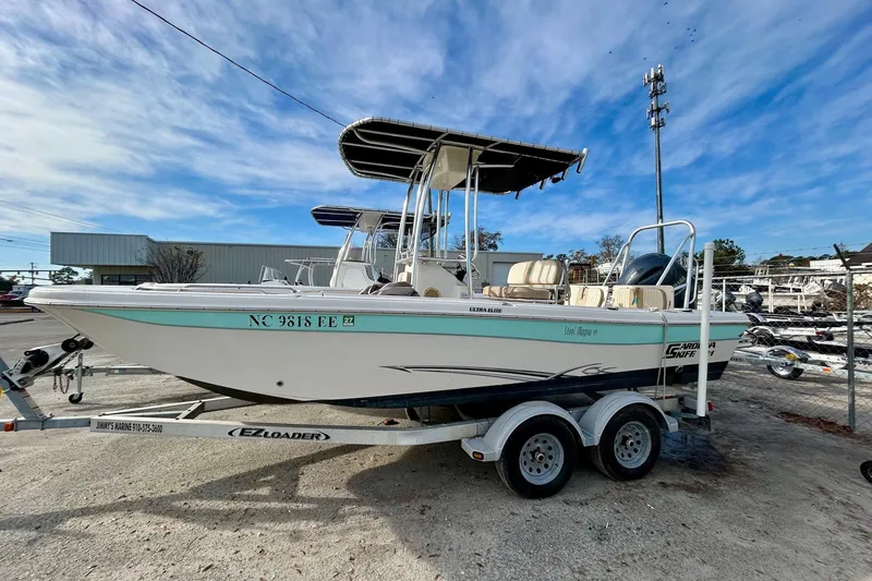 The Image of 2017 Carolina Skiff 21 Ultra Elite boat on trailer, parked outdoors under blue sky. - 1