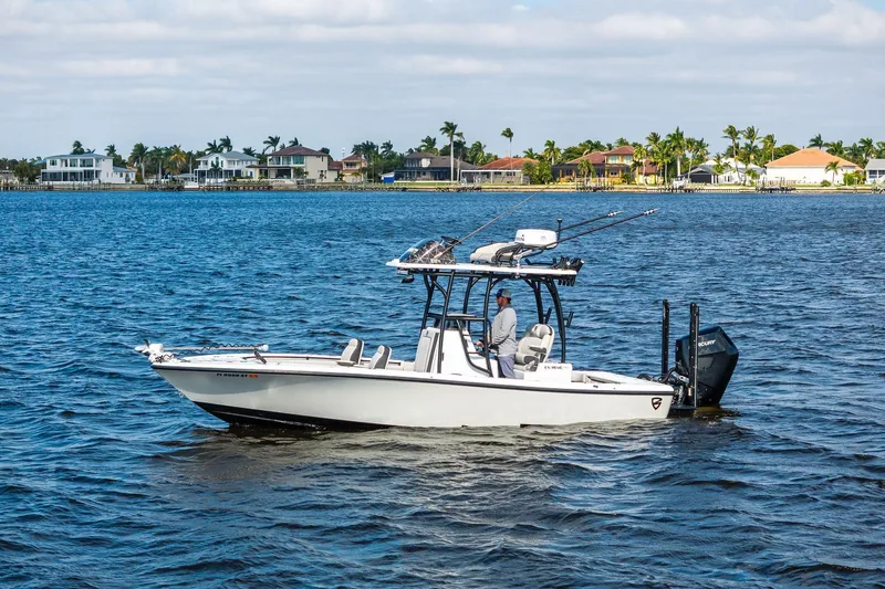 Slide: The Image of 2021 Barker Boatworks 26 Open on water near coastal homes. - 2