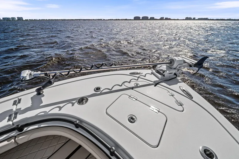 Slide: The Image of 2021 Barker Boatworks 26 Open on water, featuring deck and trolling motor. - 20