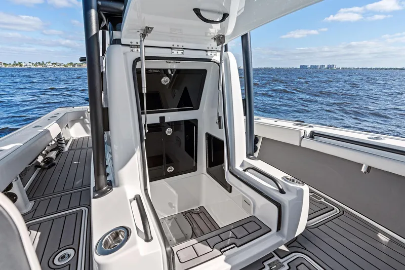 Slide: The Image of 2021 Barker Boatworks 26 Open interior with open storage compartments, on a sunny day at sea. - 31