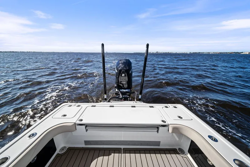 Slide: The Image of 2021 Barker Boatworks 26 Open on water, showcasing rear deck and motor. - 37