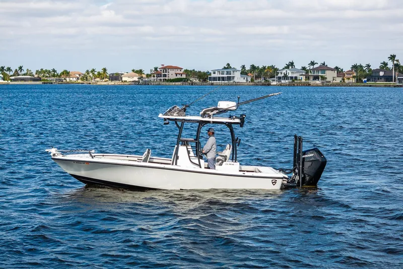 Slide: The Image of 2021 Barker Boatworks 26 Open on water, with scenic coastal background. - 13