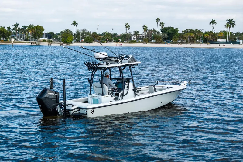 Slide: The Image of 2021 Barker Boatworks 26 Open on water, equipped with fishing gear, near a tropical shoreline. - 17