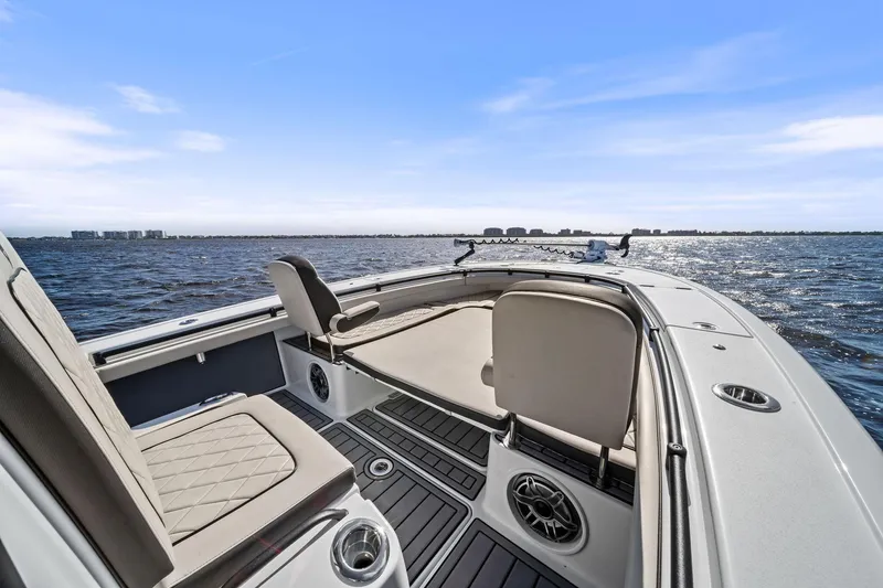 Slide: The Image of 2021 Barker Boatworks 26 Open on calm water, featuring spacious seating and modern design. - 26