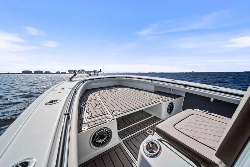 Slide: The Image of 2021 Barker Boatworks 26 Open on water, showcasing deck and seating. - 27