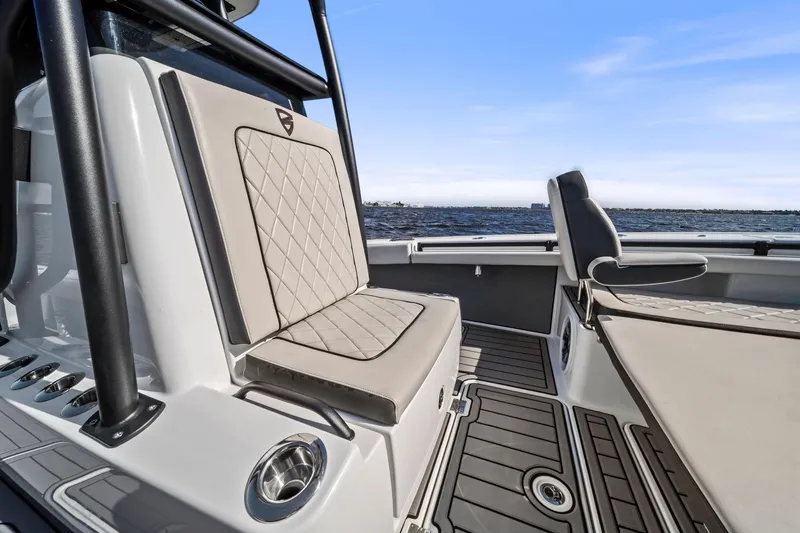 Slide: The Image of 2021 Barker Boatworks 26 Open interior with cushioned seating and ocean view. - 30