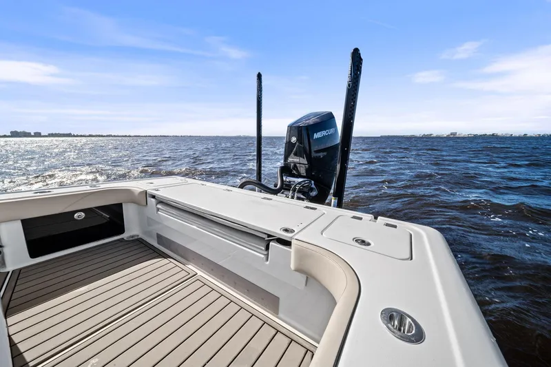 Slide: The Image of 2021 Barker Boatworks 26 Open on water, showcasing deck and Mercury engine. - 34