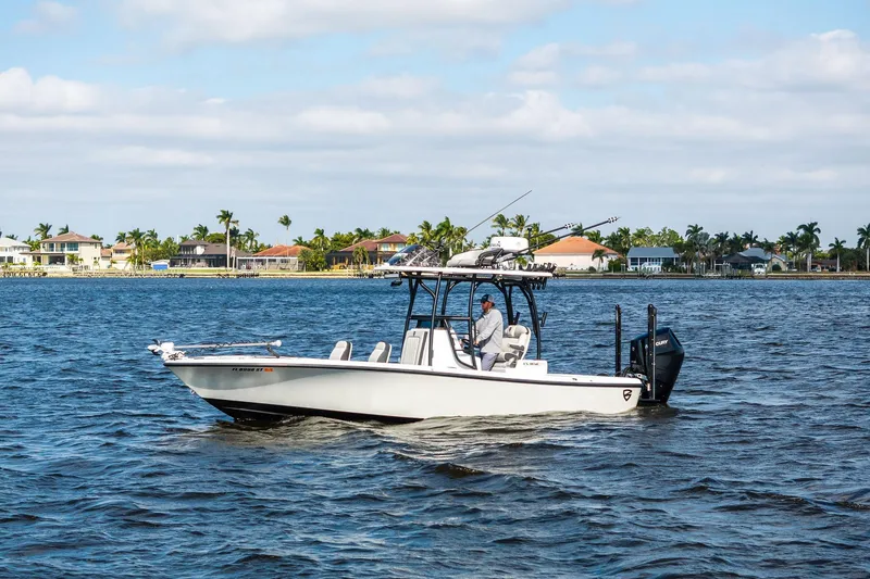 Slide: The Image of 2021 Barker Boatworks 26 Open cruising on a sunny day near waterfront homes. - 4