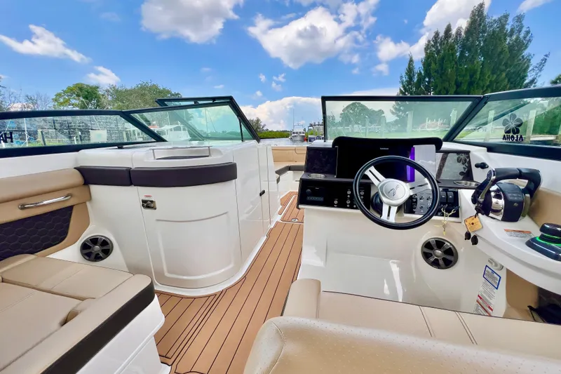 Slide: The Image of 2019 Sea Ray SDX 290 Outboard interior with tan seating and sleek design. - 12