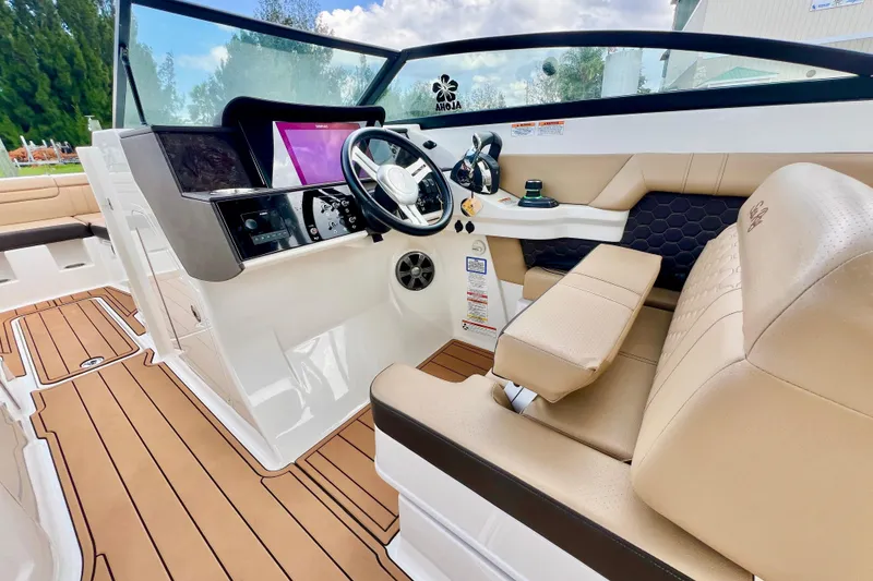 Slide: The Image of 2019 Sea Ray SDX 290 Outboard interior with beige leather seating and modern design. - 15