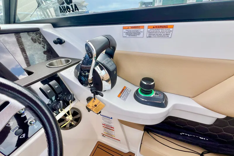 Slide: The Image of 2019 Sea Ray SDX 290 Outboard dashboard with steering wheel and navigation display. - 2