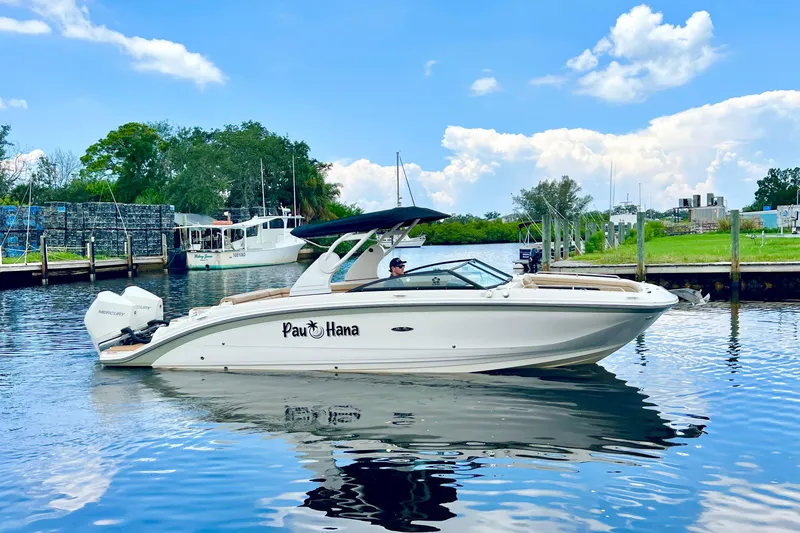 Slide: The Image of 2019 Sea Ray SDX 290 Outboard boat on water, featuring twin Mercury engines. - 24