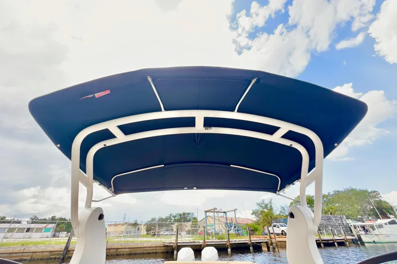 Slide: The Image of 2019 Sea Ray SDX 290 Outboard boat interior with helm and seating, dockside view. - 28