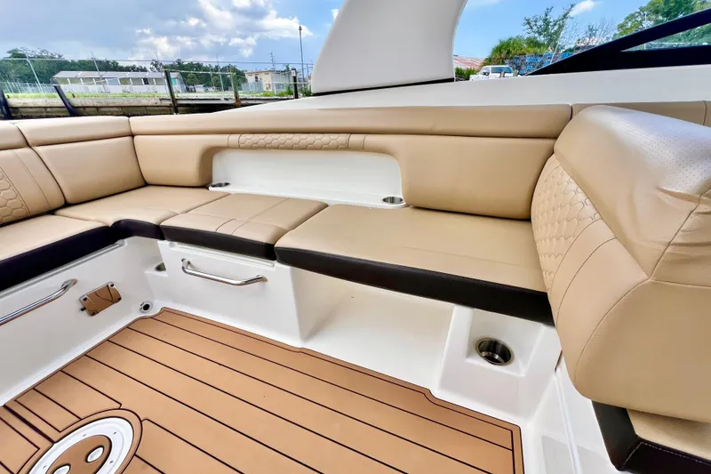 Slide: The Image of 2019 Sea Ray SDX 290 Outboard boat interior with tan leather seating and stainless steel accents. - 9