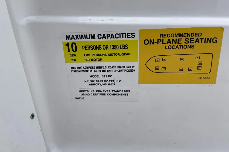 Slide: The Image of 2025 NauticStar 223 DC Deck boat capacity label, seating for 10, 1350 lbs limit. - 4
