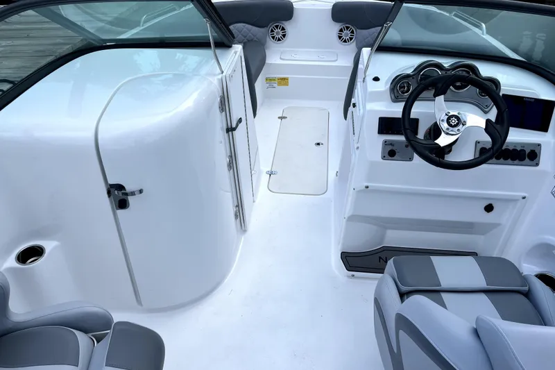 Slide: The Image of 2025 NauticStar 223 DC boat interior with steering wheel and seating. - 3