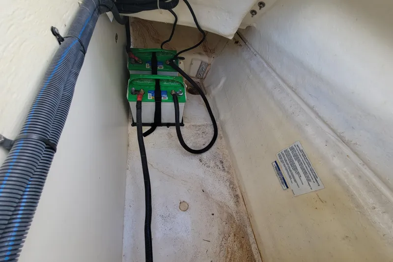 Slide: The Image of 2023 Bayliner VR6 Bowrider OB battery compartment with wiring and labels. - 26