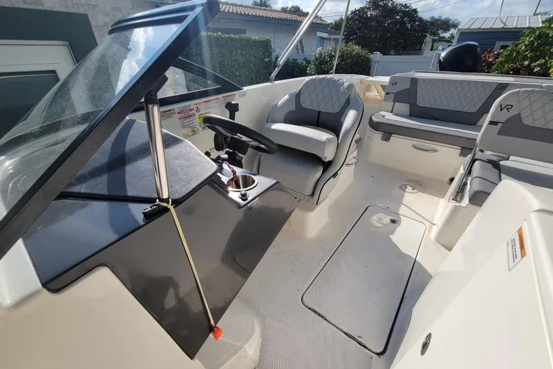 Slide: The Image of 2023 Bayliner VR6 Bowrider OB interior with steering wheel and seating. - 29