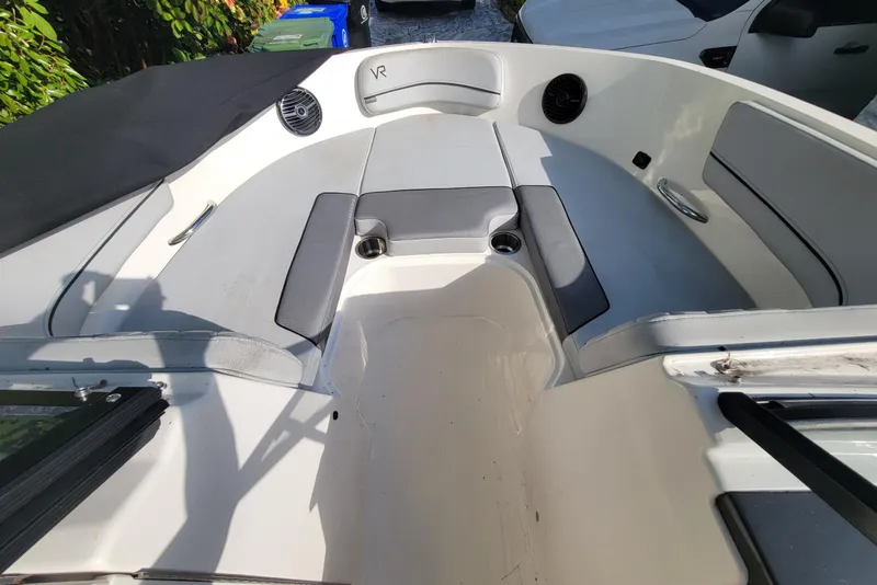 Slide: The Image of 2023 Bayliner VR6 Bowrider OB interior with gray seating and cup holders. - 30
