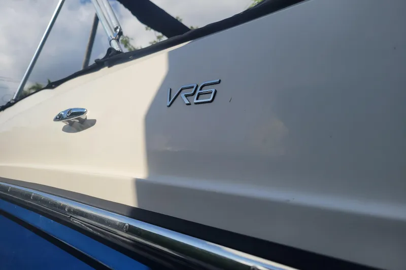 Slide: The Image of 2023 Bayliner VR6 Bowrider OB side view with logo detail. - 4