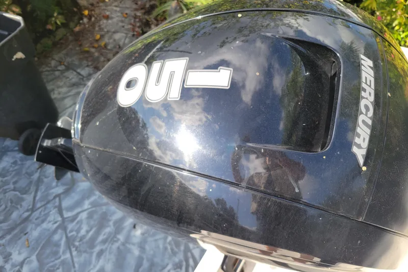 Slide: The Image of 2023 Bayliner VR6 Bowrider OB with Mercury outboard motor, reflecting sky and trees. - 9