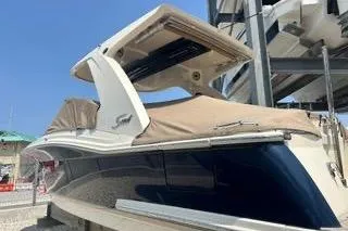 Slide: The Image of 2022 Scout 277 Dorado boat with canopy, docked under clear blue sky. - 4