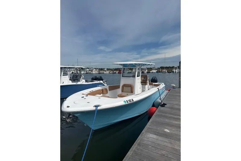 The Image of 2025 NauticStar 292 Legacy boat docked at marina under clear sky. - 0