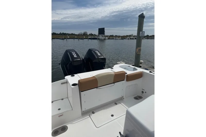 Slide: The Image of 2025 NauticStar 292 Legacy boat with dual outboard motors docked at marina. - 8