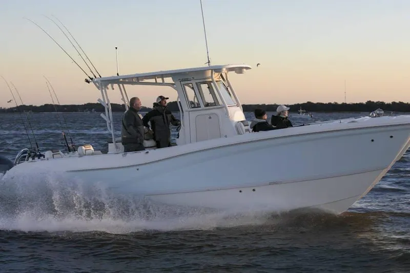 Slide: The Image of Manufacturer Provided Image: 2026 World Cat 295 CC cruising on water at sunset with passengers onboard. - 3