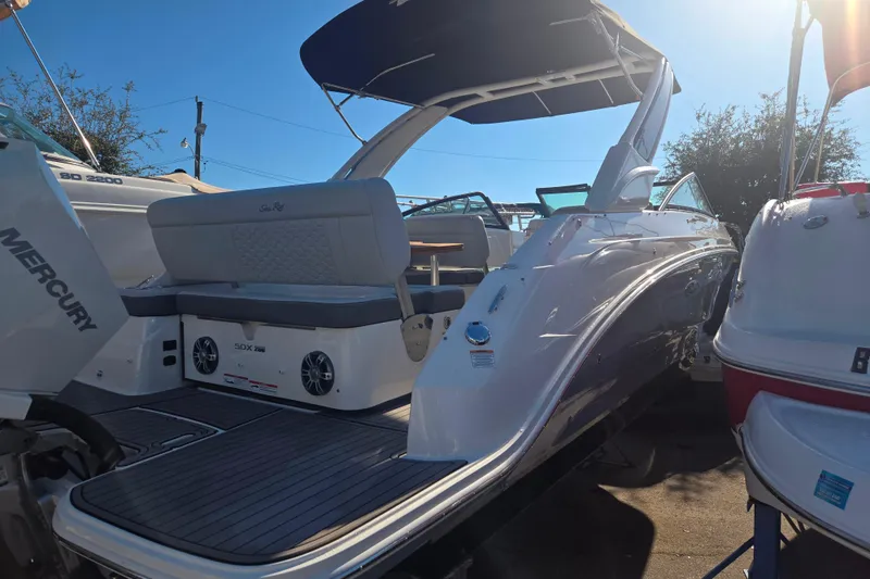 Slide: The Image of 2024 Sea Ray SDX 250 Outboard boat with Mercury engine, docked under clear sky. - 16