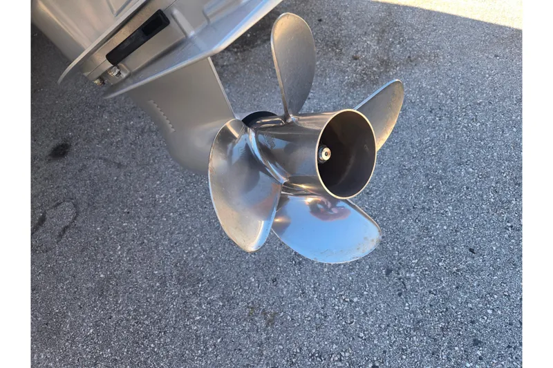 Slide: The Image of 2024 Sea Ray SDX 250 Outboard propeller on pavement background. - 20