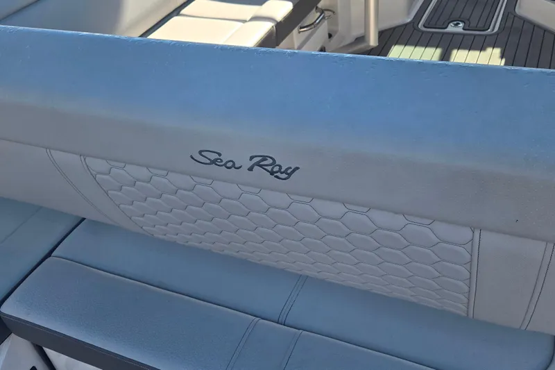Slide: The Image of 2024 Sea Ray SDX 250 Outboard interior seating with logo and hexagonal pattern. - 22
