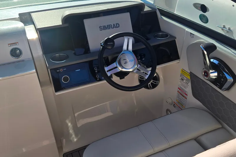 Slide: The Image of 2024 Sea Ray SDX 250 Outboard helm with Simrad display and modern controls. - 31
