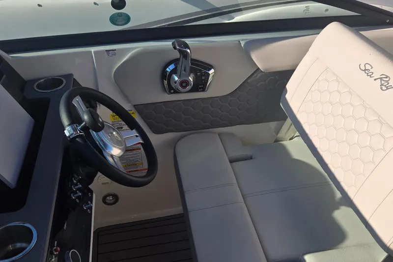 Slide: The Image of 2024 Sea Ray SDX 250 Outboard helm with steering wheel and luxurious seating. - 32